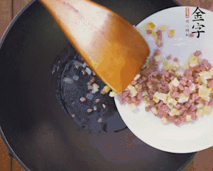 油溫3成熱時(shí)，下火腿丁、筍丁炒出香味，放豌豆粒翻炒均勻2分鐘。