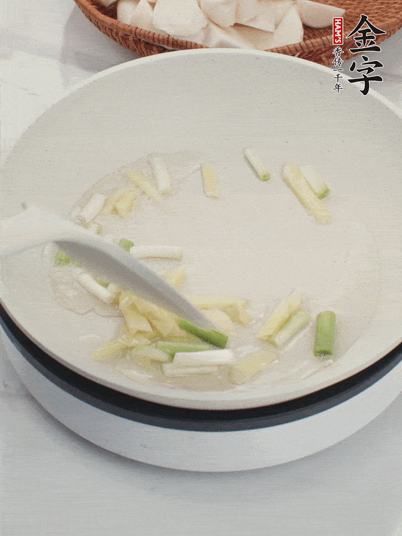 鍋中油五成熱，下蔥白、姜片爆香。